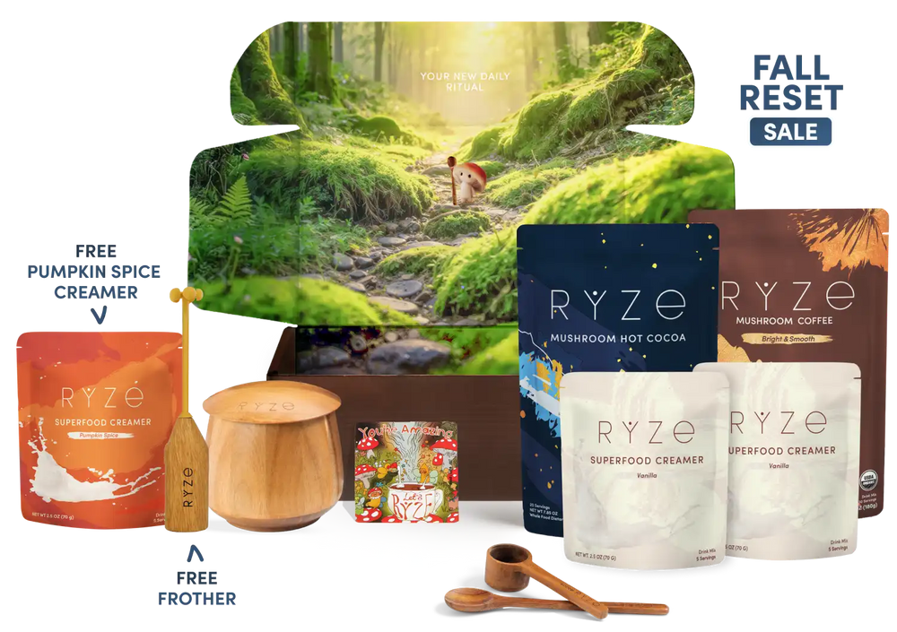 RYZE fall gift set featuring a forest-themed box, RYZE Mushroom Hot Cocoa, RYZE Mushroom Coffee, RYZE Superfood Creamer flavors, a free pumpkin spice creamer pouch, a free frother, and wooden measuring tools, with a 'FALL SALE' badge.