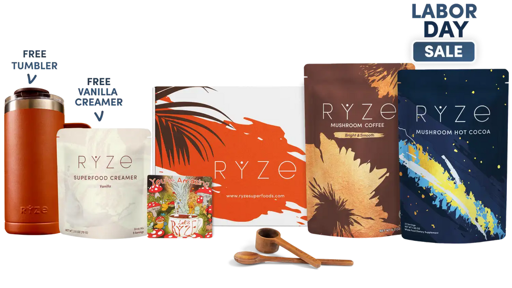 A Labor Day sale bundle from RYZE Superfoods featuring a brown insulated tumbler, a vanilla creamer pouch, a small dessert mix pouch, a coffee pouch, a hot cocoa pouch, wooden spoons, and a scoop, arranged on a white background with promotional text overlays.