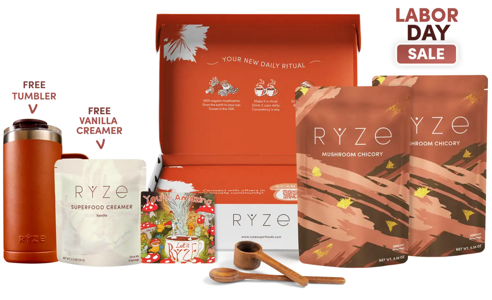 RYZE Labor Day gift set featuring mushroom chicory and vanilla creamer pouches, a tumbler, wooden measuring tools, and an open orange gift box on a white background with a 'Labor Day Sale' badge.