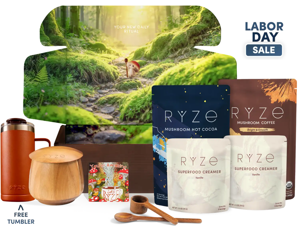 A RYZE Labor Day gift set featuring mushroom hot cocoa, mushroom coffee, two creamer pouches, wooden measuring tools, a wooden mug, and a free tumbler, arranged in front of a large forest-themed box graphic with a 'Labor Day Sale' badge.