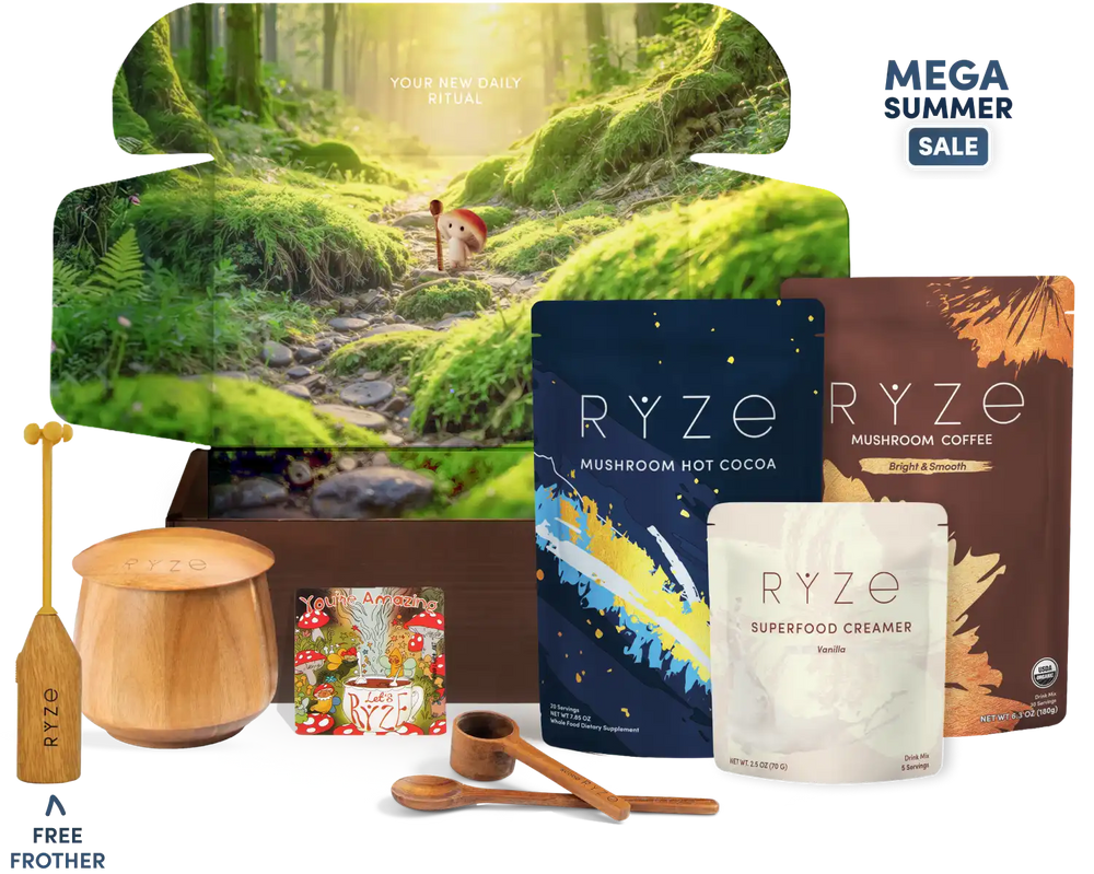 A RYZE gift set arranged on a white background with a large forest-themed box behind it. Visible items include a wooden spoon, wooden scoop, wooden container, a small packaged item, two RYZE pouches (mushroom hot cocoa and mushroom coffee), and a white pouch of superfood creamer.